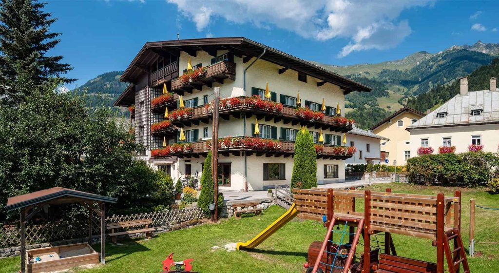 Hotel Steindlwirt in Dorfgastein mit Garten und Spielplatz, umgeben von Bergen. Familienfreundlich.